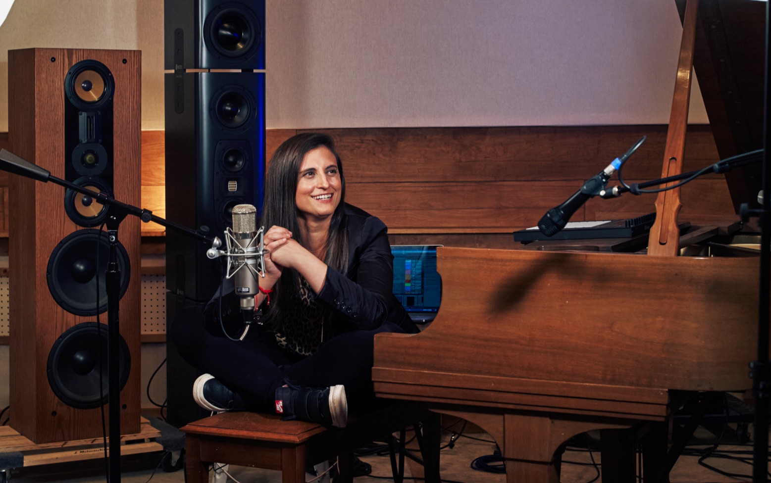 Natalie Tenenbaum in a recording studio beside a grand piano